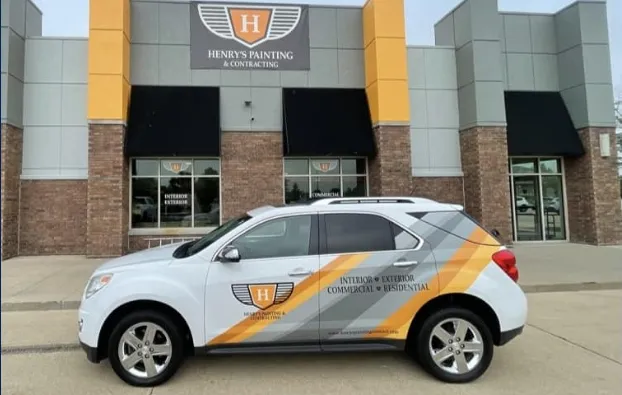 Henry's Painting & Contracting headquarters featuring a branded company vehicle, showcasing our leading painting services.