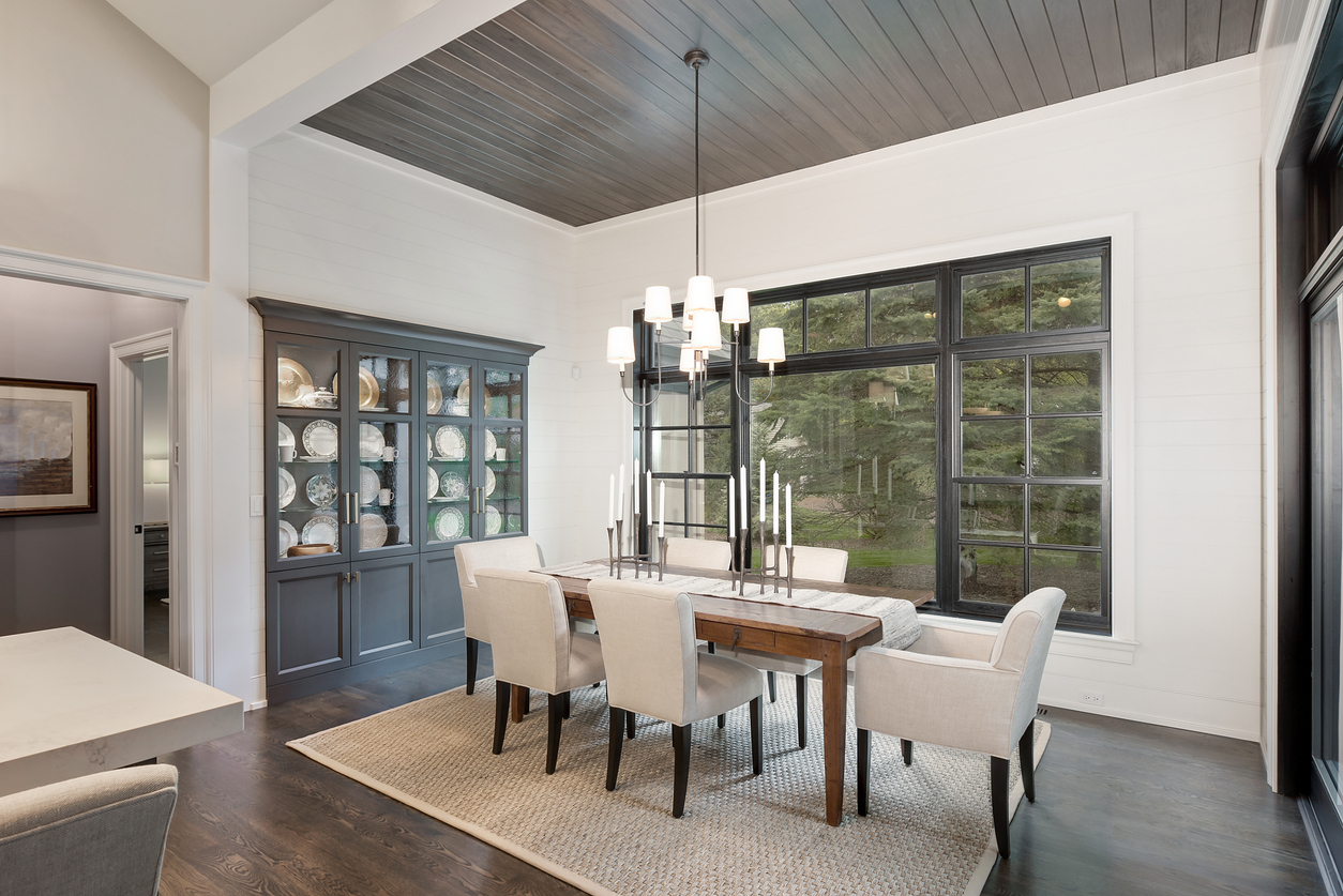 Modern dining room with cabinets, freshly painted in contrasting shades of gray.